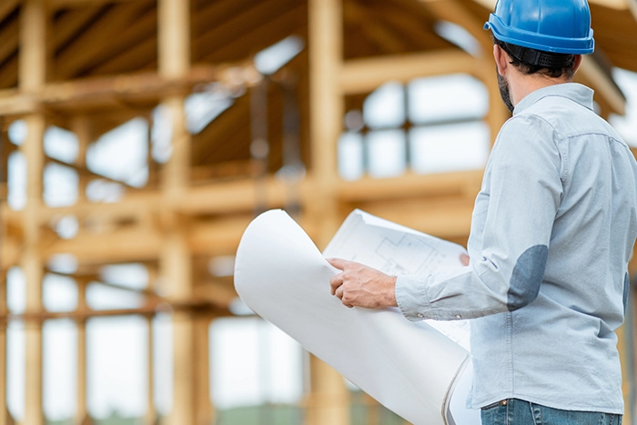 engineer with a blueprint | real estate sales